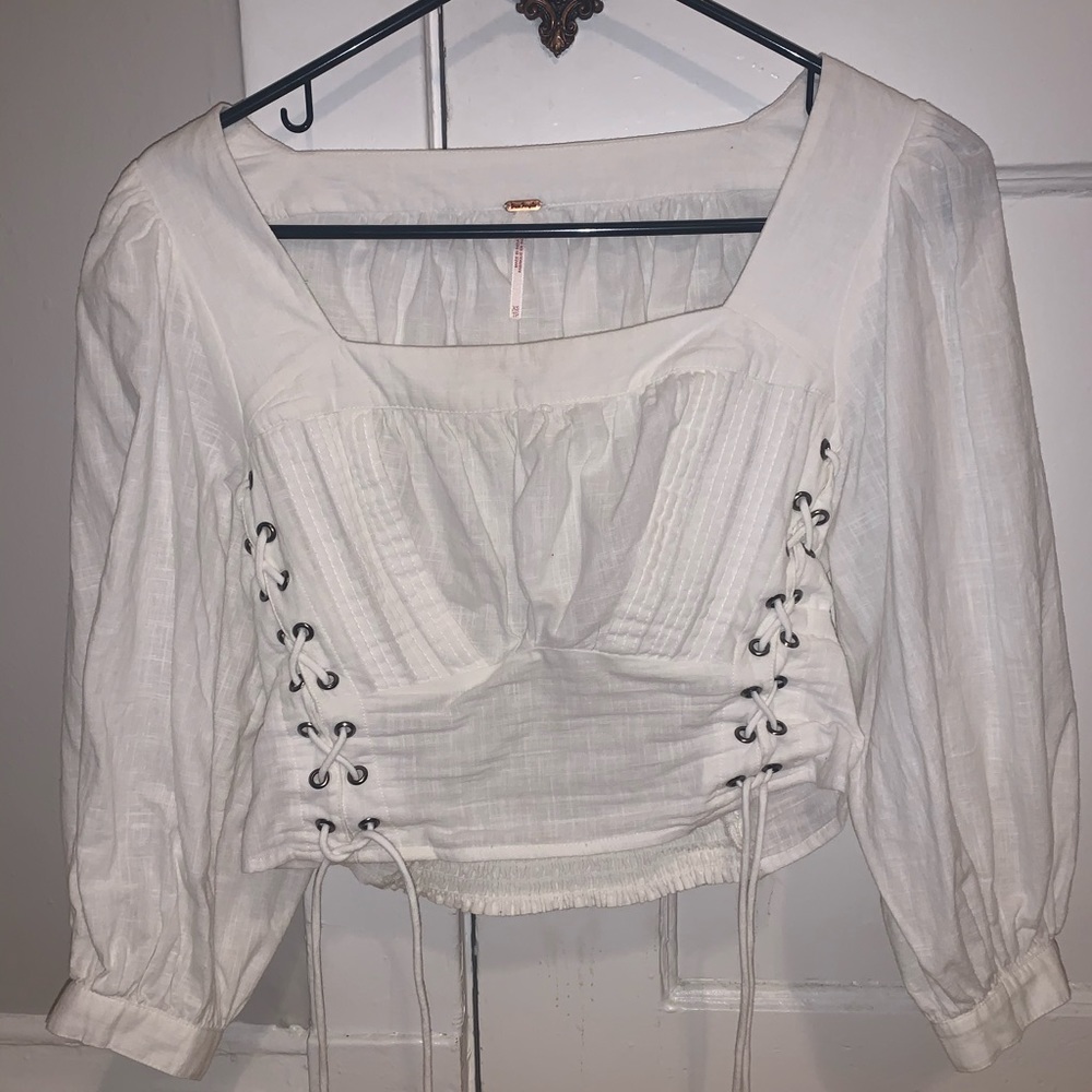 White free people blouse. Slightly poofy sleeves.